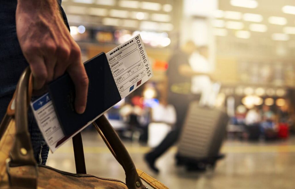 pessoa segurando passagem de avião
